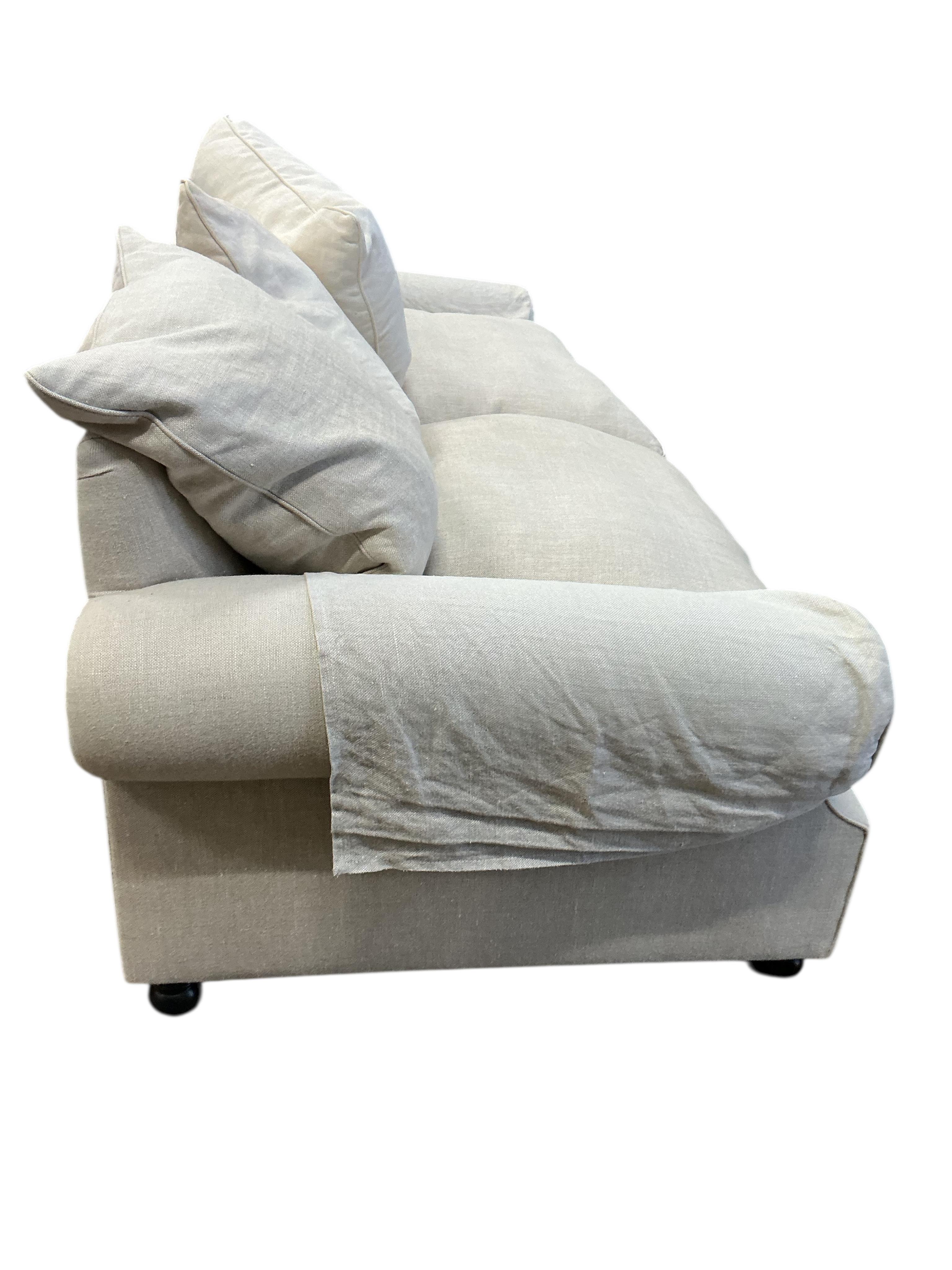 A Contemporary three seater sofa upholstered in natural fabric, width 220cm, depth 100cm, height 90cm